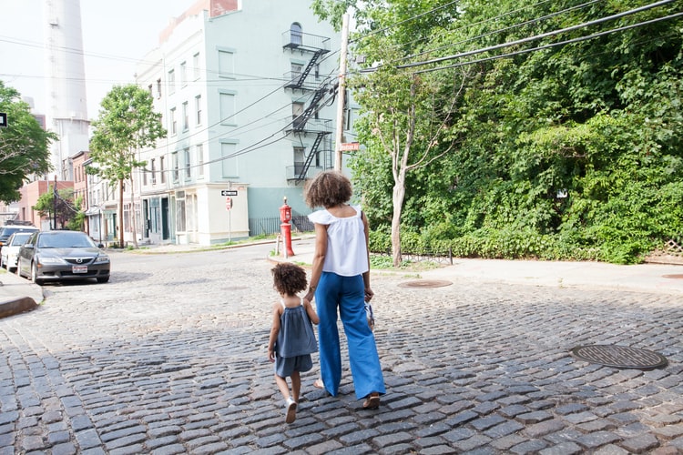 a little girl going to school with her mother