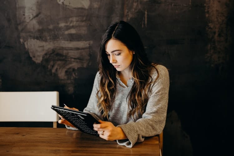 Student job: a young woman using a digital tablet