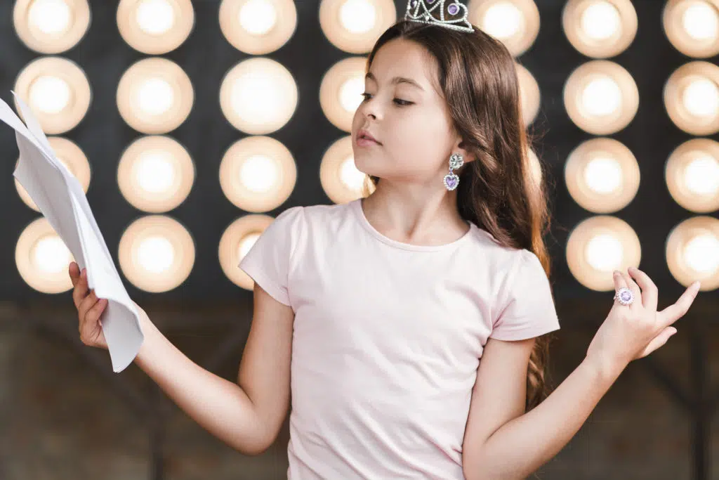 child care at home : theater activity, a little girl playing a role 