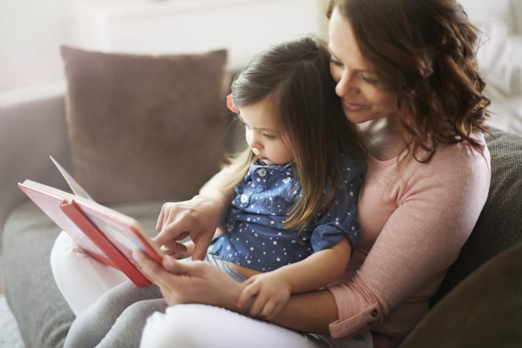 a reading moment between mother and daughter