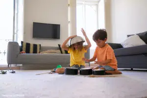 Nanny at home: two children playing