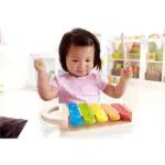 A child playing with a xylophone