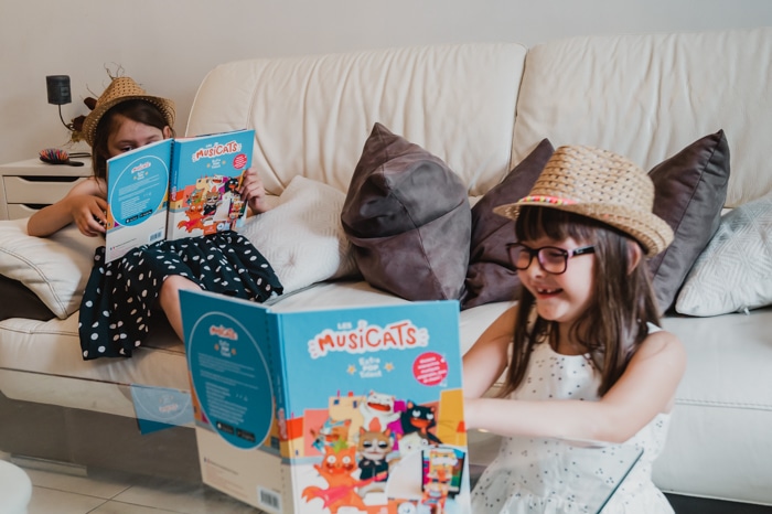 deux petites filles en train de s'amuser en feuilletant des livres