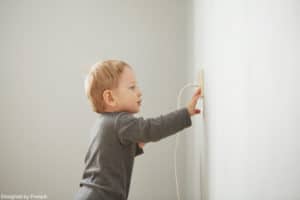 A child putting his fingers in a socket