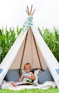 Child in a teepee enjoying his vacation