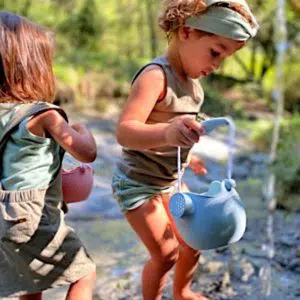 children playing with a watering can 