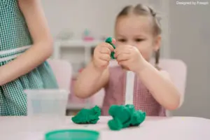early learning activities: a girl playing with play dough