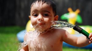 A child cooling himself with water