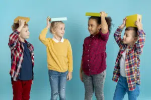 Des enfants avec un livre sur la tête
